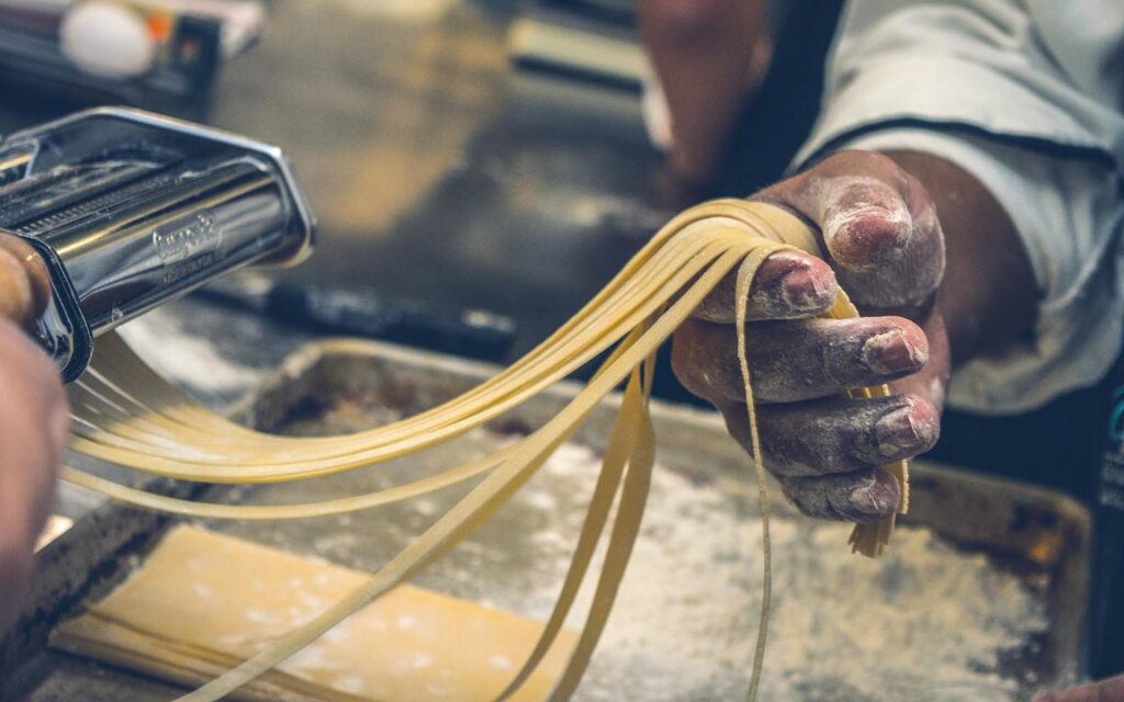 Chef making fresh pasta using maida flour – refined flour in processed food