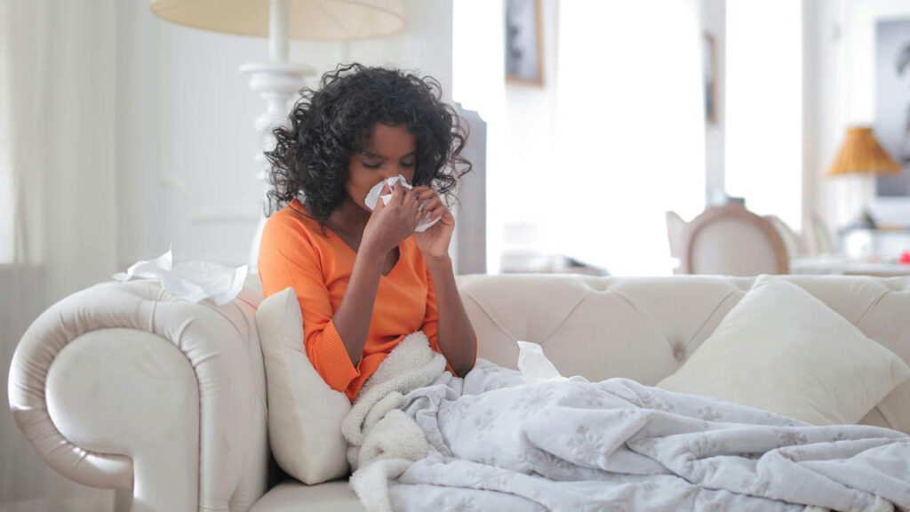 Woman resting on couch due to pneumonia symptoms