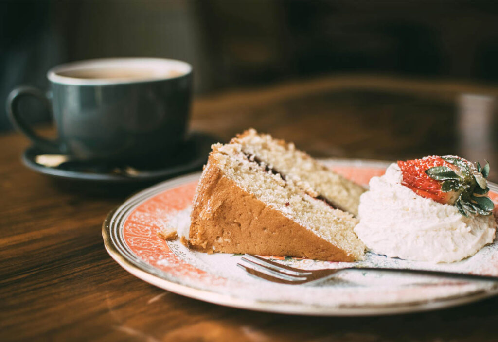 Sugary dessert on plate with coffee – hidden sugar in daily food Daily Posion